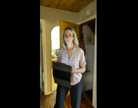 Woman with plastic wrap watermelon on head walks to mom