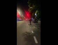 Professional guy skateboards with ski sticks