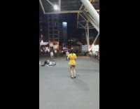 Guy and girl kick pass birdie outside 