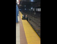 Guy stands on tracks at subway station 