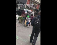little boy green helmet holding on to bike