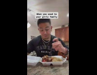 Guy ignores fighting continues eating food 