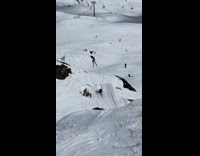 Skier rolls downhill after bumpy slope 