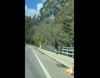 Woman spin umbrella dance on bridge bag