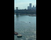 Tugboat pulls full boardwalk through East River