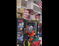Guy in astronaut outfit loads shopping shelves 