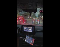 Two polaris slingshot cars driving on the road with LED light designs 
