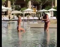 Woman in bikini poses in the swimming pool