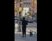 2 men throw items at each other on sidewalk 