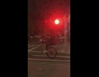 Man Rides Bike on Hind Wheel Only