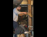 Guy rubs raccoon skin on pole 