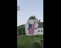 Guy punches air large american flag house