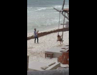 Woman brown dress sat on the swing and stretches her body