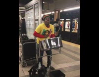 Man sings "Could You Be Loved" Bob Marley at subway station, playing Jamaican steel drum