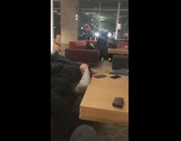 Guy stands on lobby chair for photo 