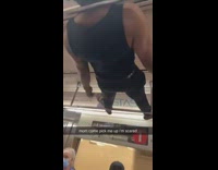 Guy in black dances through ceiling bars of train 