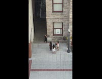 Two girls black dress hat sit lower alley