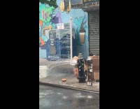 Pole attached to fire hydrant splash water