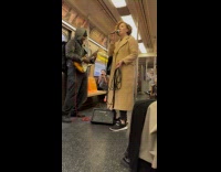 Man and woman performs during train ride