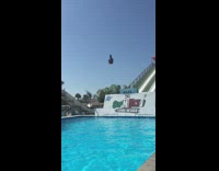 Guy slides off Slip and Fly does spinning front flip cannonball and face plants into swimming pool