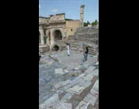 Woman white dress spin around stone ruins