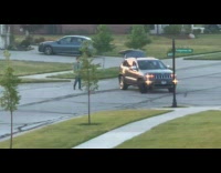 Collab IITW - Man walks while car circles around him at the parking lot