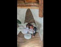 Girl in white outfit on white pillows