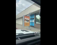 Guy looking at build a bussy sign