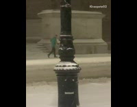 Green shirt guy jogs while it snows 