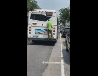 Guy hangs onto back of bus for free ride 