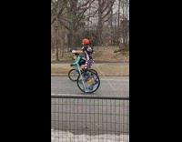 Guy wearing american flag shorts rides unicycle 