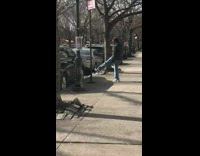 man kicks street sign pole