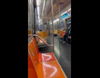 Man smoking opens window inside the train. 