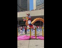 People at dragon costume jumps at high poles