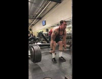 Guy deadlifts heavy weights and trips over bench at the gym