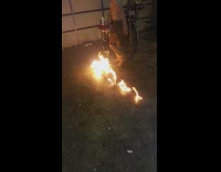 Shirtless guy fire garage lighter fluid 