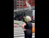 Collab WINY - Woman green parrot on shoulder cross street