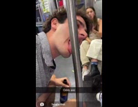 Guy lick stainless metal pole in train