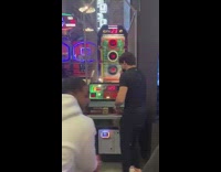 Guy misses poorly at football throw game at arcade