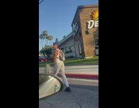 Guy signals his arm while driving with his Heelys 