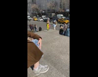 Woman in yellow pants poses at the park