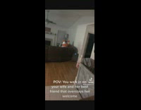 Two women in living room dressed as traffic cones 