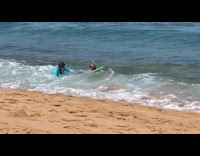 Dad and sister struggle to get up beach