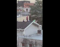 People in costume sit drink on roof