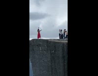 Woman red dress photo shoot edge cliff