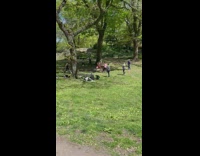 Guy and Lady Have Sword Fight at Park