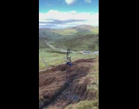 Bikers scorpion off hilly trail 