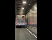 Bus inside tunnel shows Call Police sign