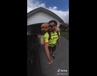 Guy rides bicycle dog red backpack goggles