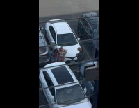 Two women poses and dance parking lot